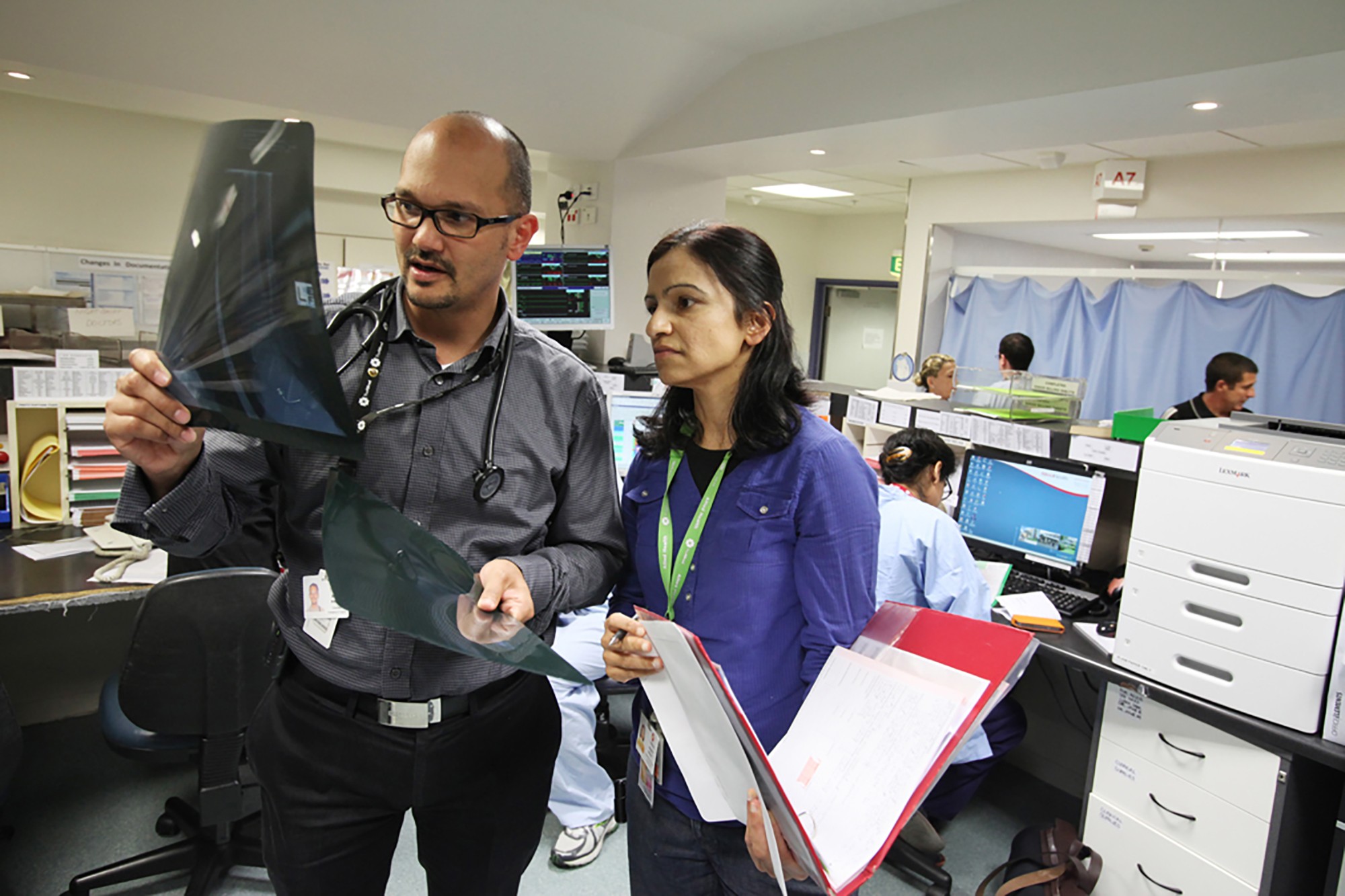 Doctor and physiotherapist looking at X-Ray