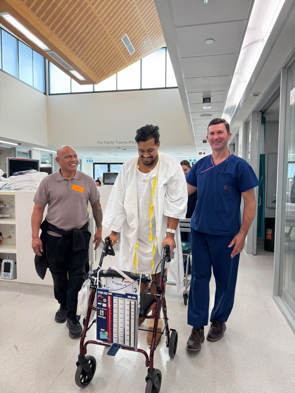 With his uncle on one side and physio Scott Bradley on the other, Mona takes his first steps after coming to hospital