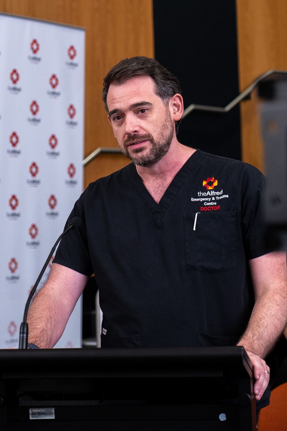 Emergency physician Dr David McCreary speaking at lectern 
