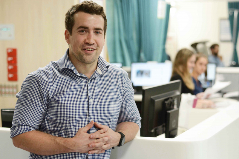 Study co-ordinator, Jack, standing in the Neuroscience Clinical Trials Unit.