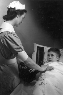Historical photo of nurse looking after paediatric patient