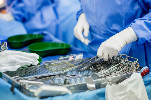 Surgeon reaching for sterile equipment
