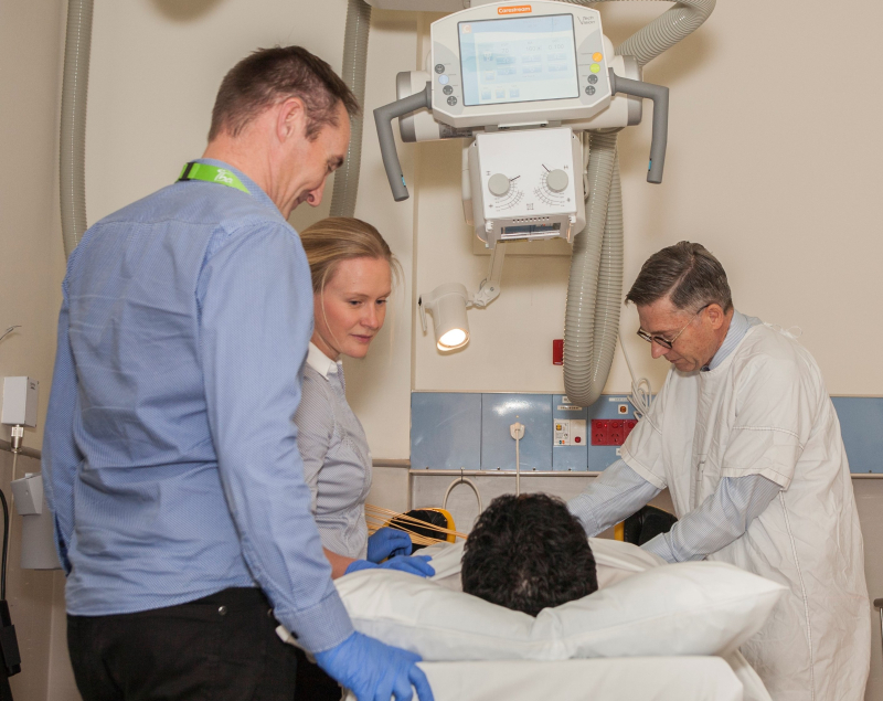 Prof. Jeremy Millar (right) with Alfred staff and patient.
