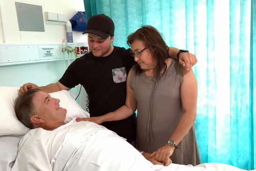 An Alfred patient is surrounded by his family