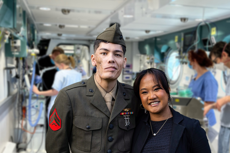 Travis and Jasmine standing together with backdrop of Hyperbaric Unit