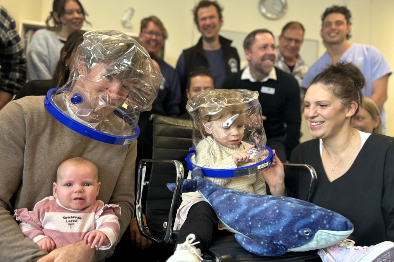 Baby Willow with family wearing her 'space helmet'