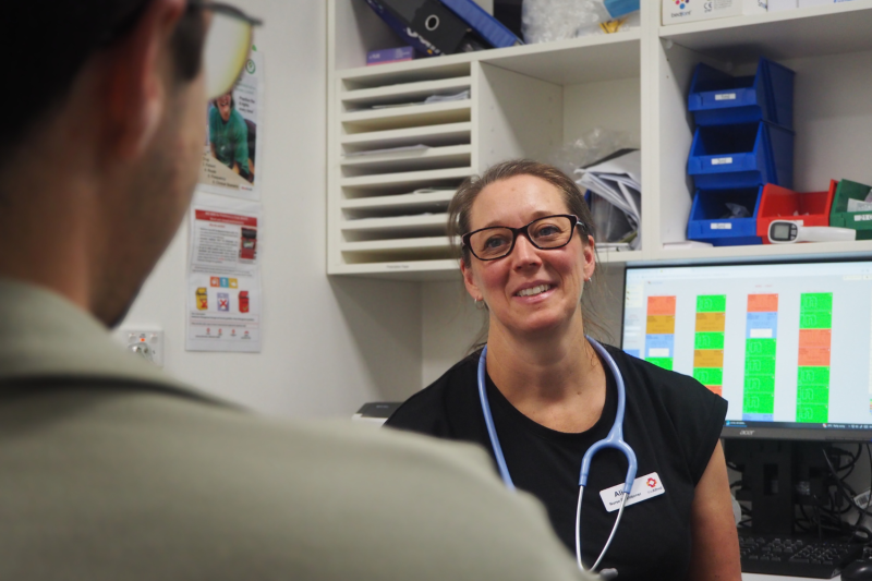 Nurse Practitioner Alice Ryan speaks with a colleague in a treating room