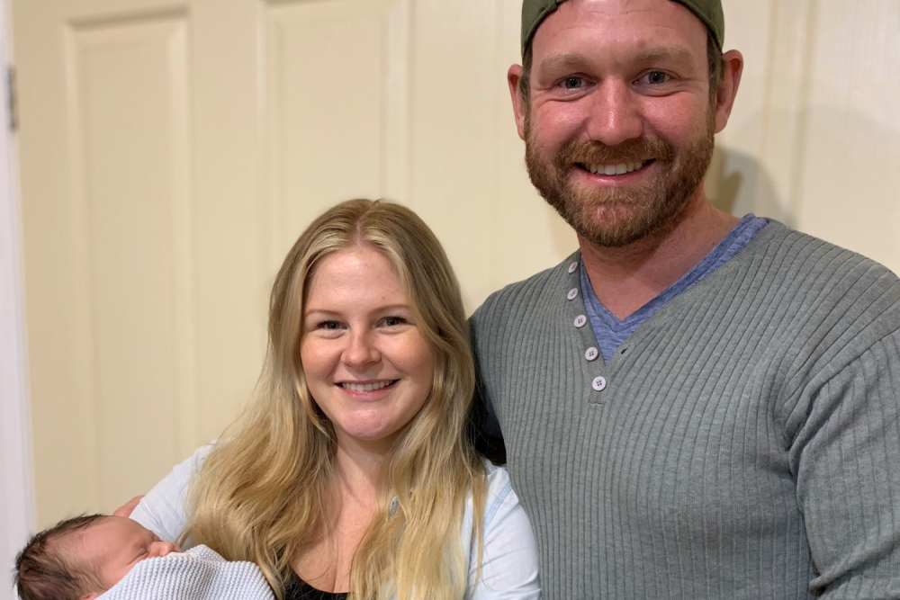 Steve with his partner and new baby
