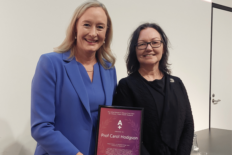 Prof Carol Hodgson receiving Research Week award from Prof Karen Adams