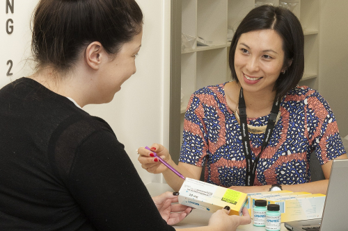 Pharmacist discussing medications with an outpatient in the clinic