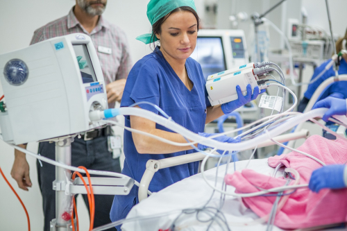 ICU nurse setting up IV equipment